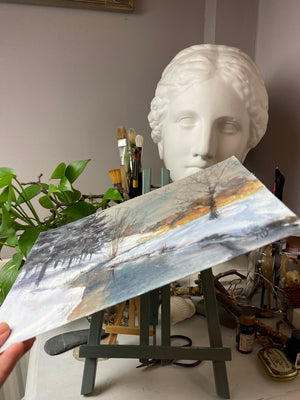 Side view of the Winter River at Dusk original watercolour, showing the unframed sheet of paper and its painted surface.
