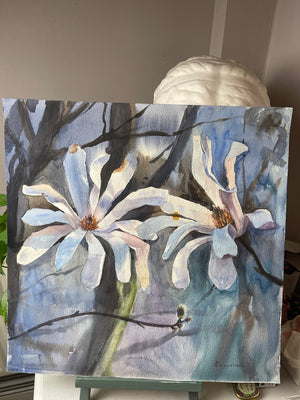 Close view of the pale magnolia petals, lilac-blue washes and dark branches in Magnolia in Soft Light.
