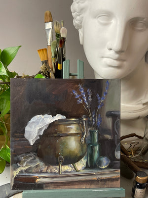 Close view of the signed Brass and Lavender oil still life, with a brass pot, white cloth and green glass bottle.
